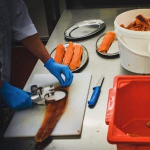 Hand slicing smoked trout